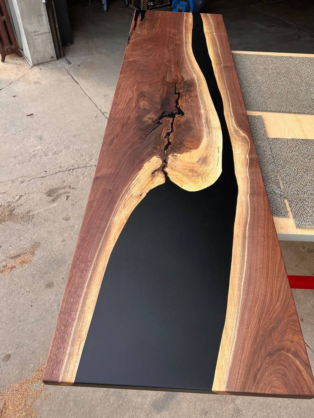 Full length view of the black epoxy walnut dining table