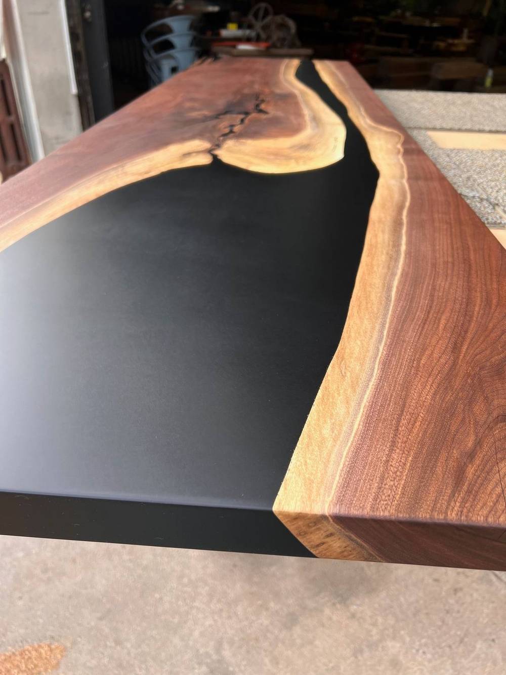 Wide black walnut slab top showing dark heartwood, pale sapwood and figure