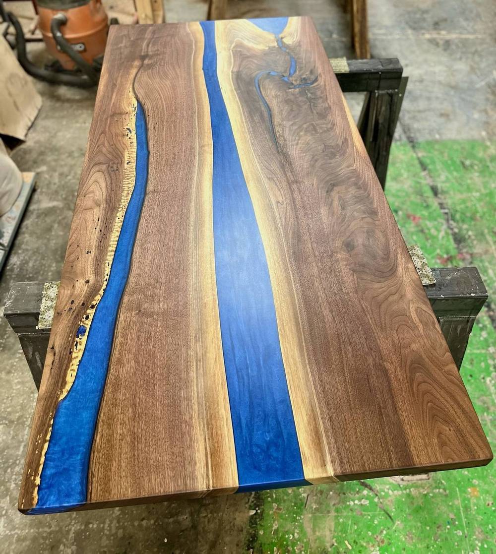 Live edge slabs joined with a blue epoxy river