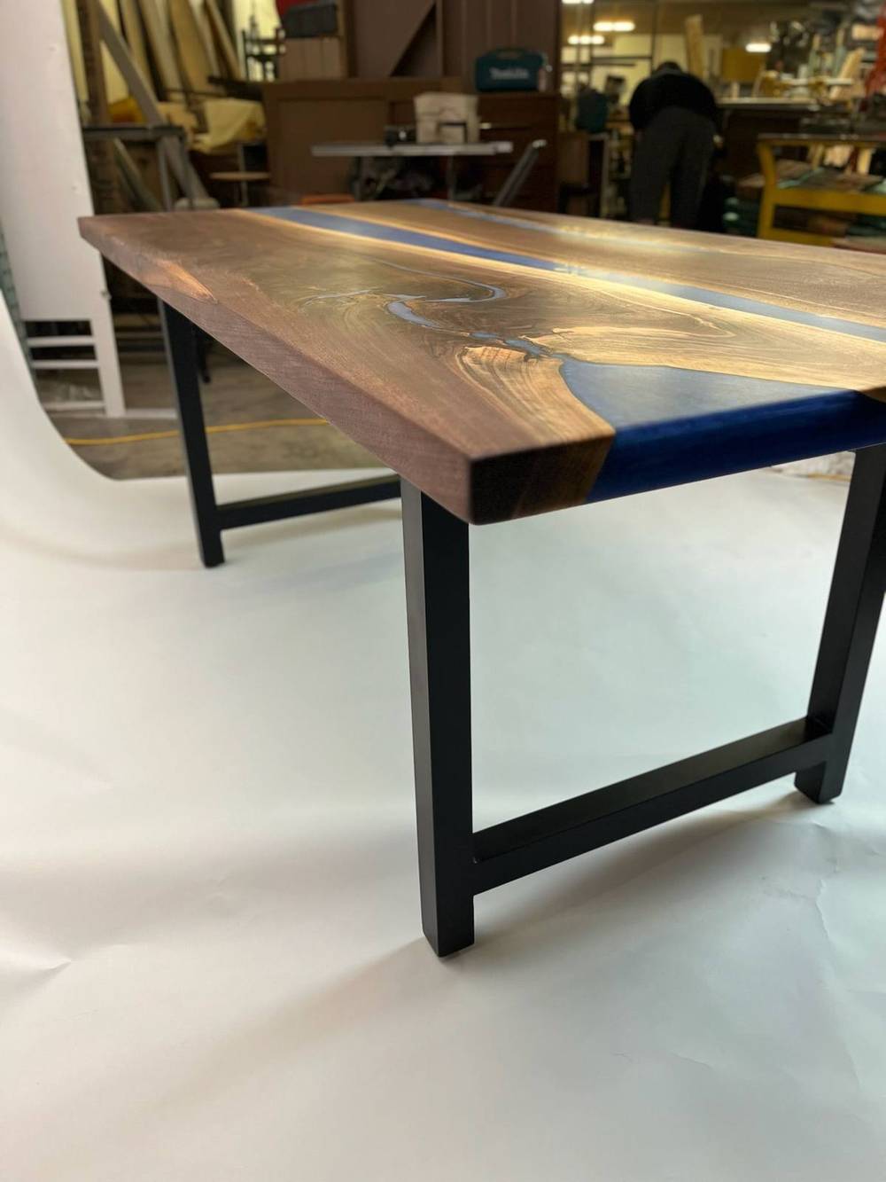 Trapezoid steel base under the blue river walnut table