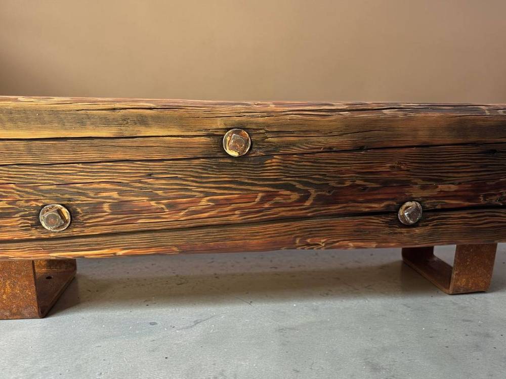 Exposed bolt detail joining the bench top to its legs