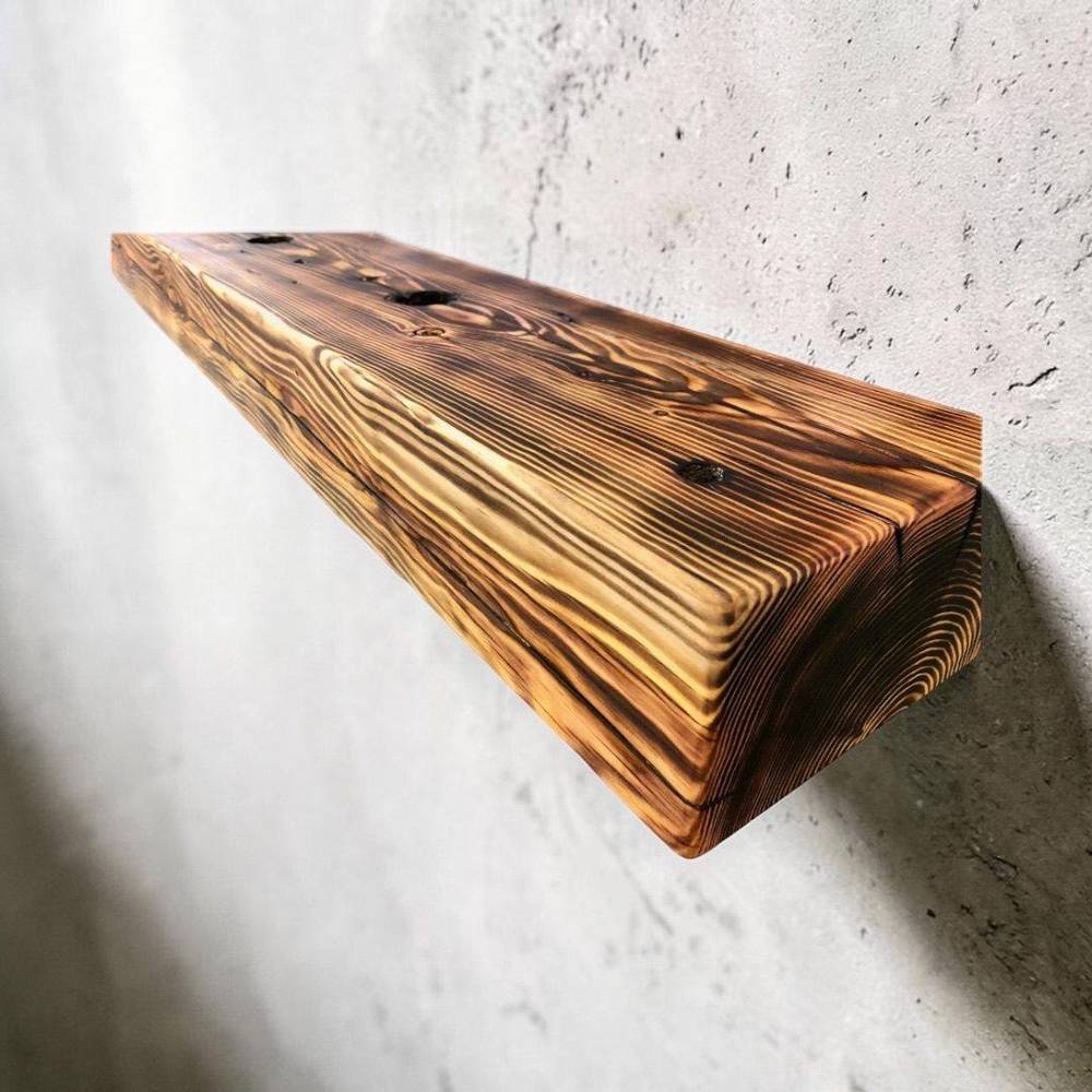 Reclaimed oak boards mounted as floating shelves on a wall
