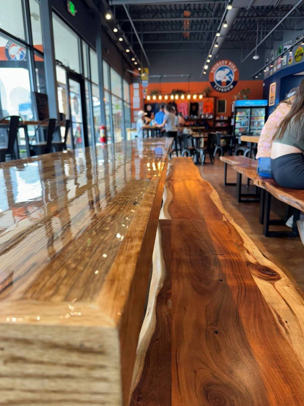 Live edge rail running along the brewery wall