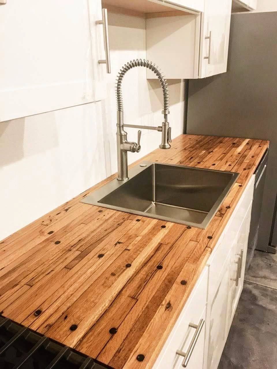 Boxcar flooring installed as a kitchen countertop around a sink