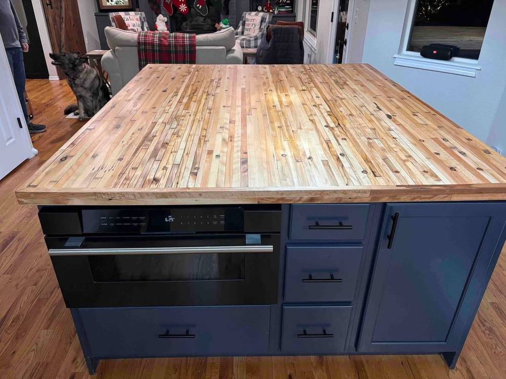 Navy kitchen island with a reclaimed wood top