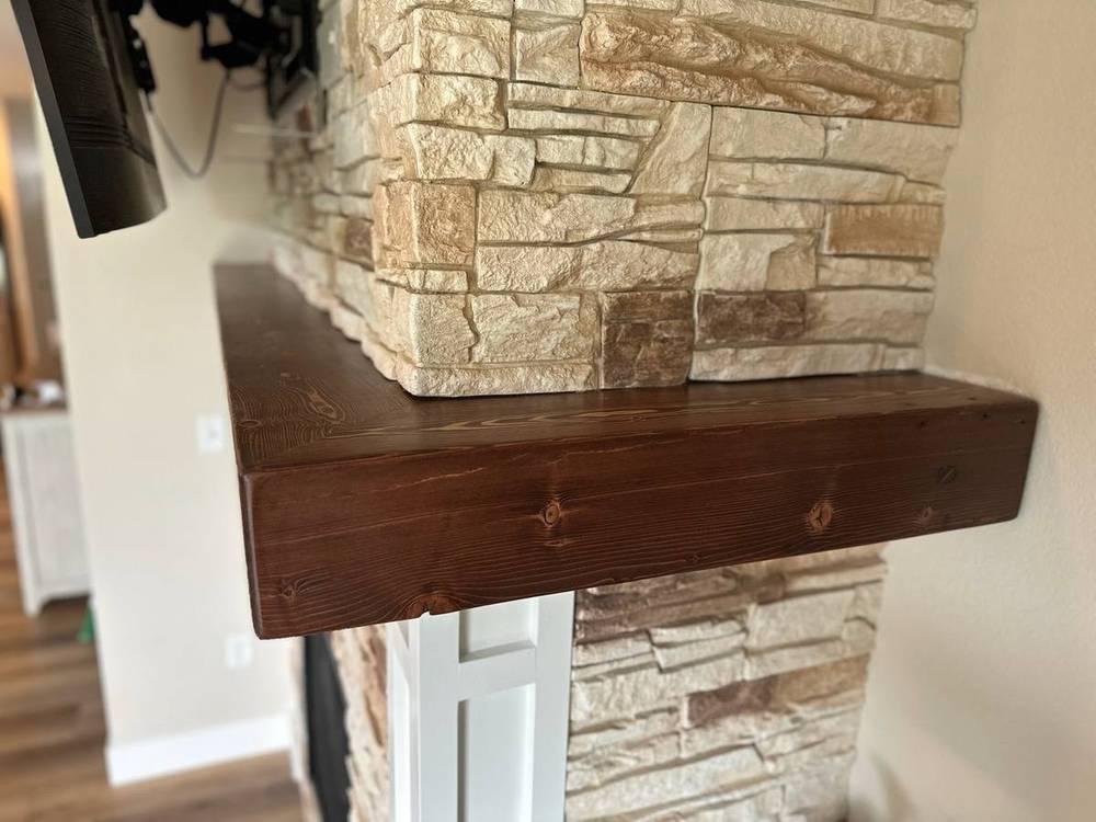 Corner detail of a hand-hewn beam mantel