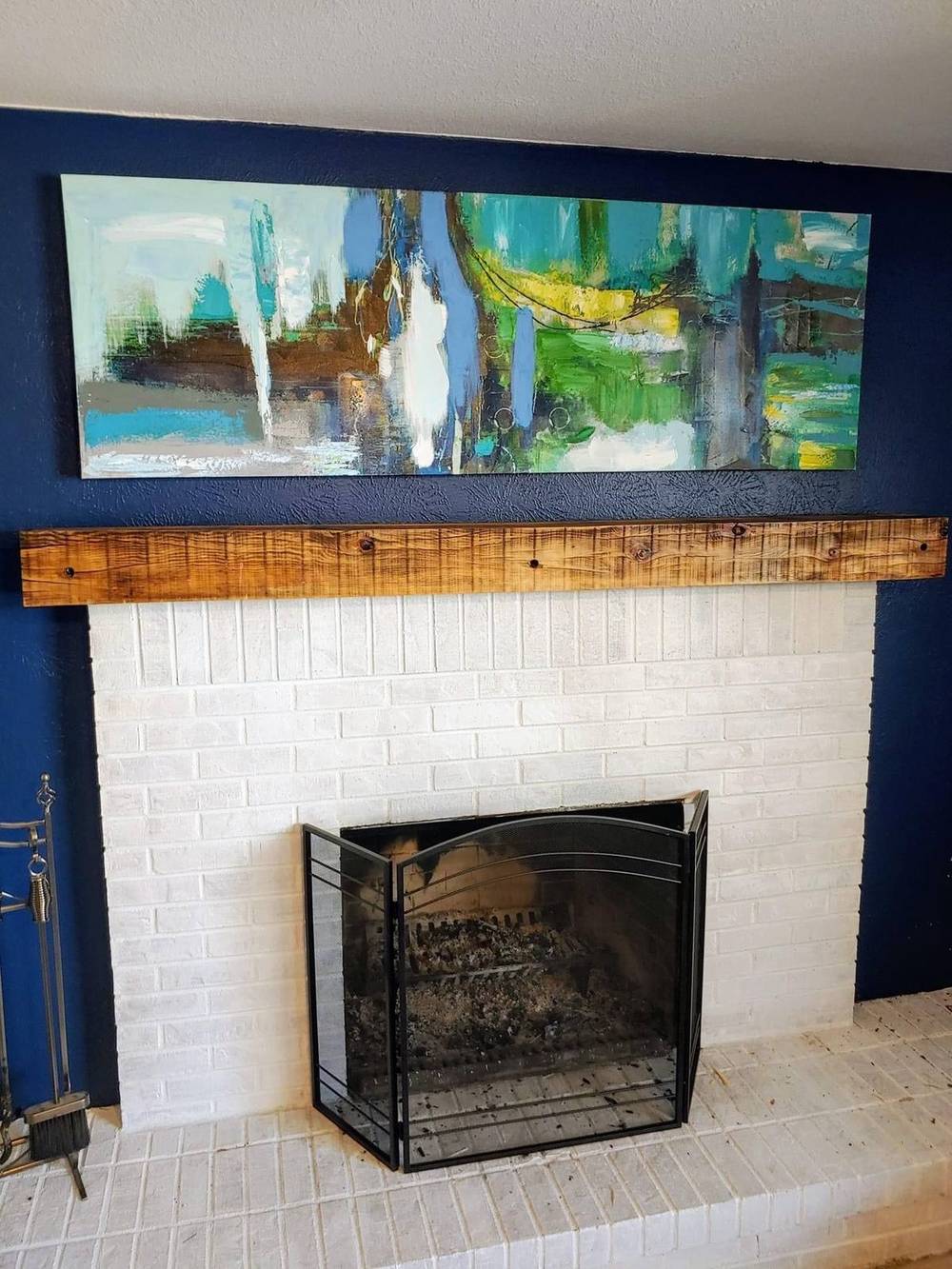 Reclaimed mantel above a blue tile surround
