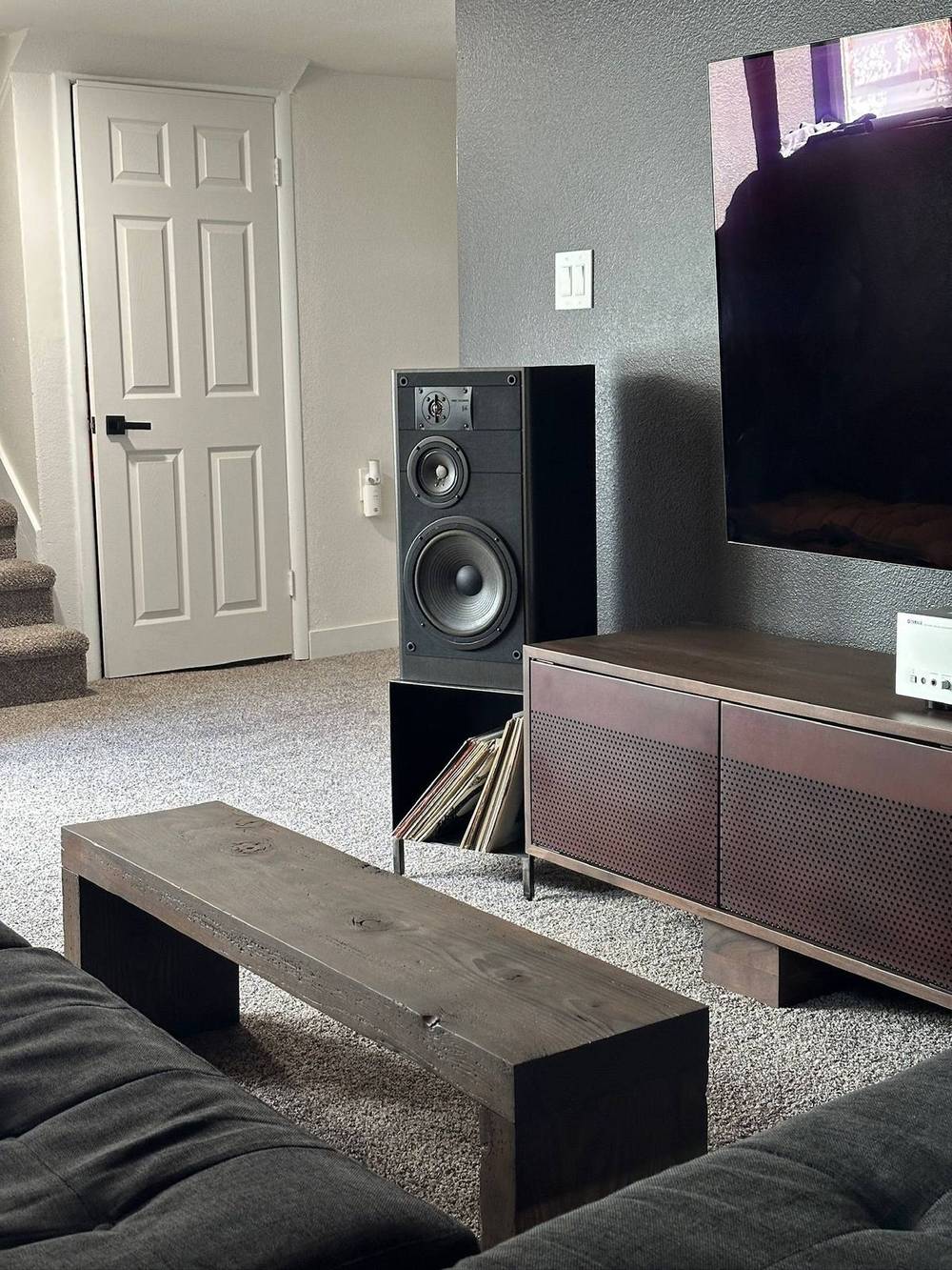 Reclaimed beam used as a media shelf