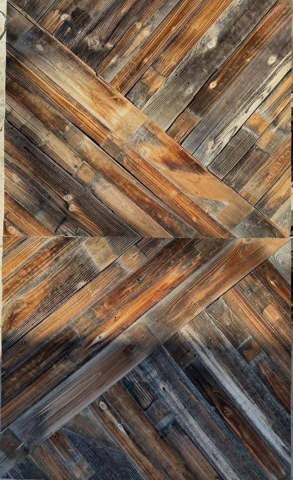 Reclaimed barnwood installed in a herringbone pattern as an accent wall