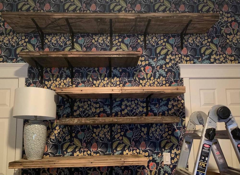 Barnwood shelving against patterned wall